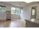 Kitchen with white cabinets, stainless steel dishwasher, and view to backyard at 16308 Rock Lake Dr, Odessa, FL 33556