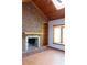 Gathering room with brick fireplace, built-in shelving, and hardwood floors at 16308 Rock Lake Dr, Odessa, FL 33556