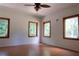 Bright bedroom with hardwood floors and multiple windows offering ample natural light at 16308 Rock Lake Dr, Odessa, FL 33556