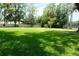 Spacious backyard with a grassy lawn and mature trees, providing ample outdoor space at 16308 Rock Lake Dr, Odessa, FL 33556