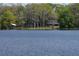 Peaceful lakefront view showcasing a home nestled among trees at 16308 Rock Lake Dr, Odessa, FL 33556