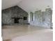 Large living room featuring a dramatic stone fireplace and tile flooring at 16308 Rock Lake Dr, Odessa, FL 33556