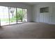 Bedroom with sliding glass doors to backyard, carpet, and built-in dresser at 16308 Rock Lake Dr, Odessa, FL 33556