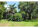 Two story home with balcony, lush landscaping and large trees at 16308 Rock Lake Dr, Odessa, FL 33556