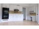 Kitchen with white cabinets, tile floors, and built-in desk area at 16308 Rock Lake Dr, Odessa, FL 33556