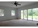 Bright bedroom with sliding glass doors leading to the backyard and a ceiling fan at 16308 Rock Lake Dr, Odessa, FL 33556