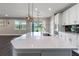 Modern kitchen with island, stainless steel appliances, and white cabinets at 10320 Stallion Fields Way, Tampa, FL 33647