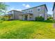 Expansive grassy backyard showcasing the home's rear elevation at 10320 Stallion Fields Way, Tampa, FL 33647