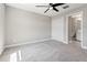 Spacious bedroom with ensuite bathroom access and ceiling fan at 10320 Stallion Fields Way, Tampa, FL 33647