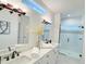 Elegant bathroom with double vanity, frameless shower, and marble floors at 17423 Metcalf Ave, Port Charlotte, FL 33954