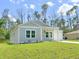 Charming one-story home with a gray exterior and a two-car garage at 17423 Metcalf Ave, Port Charlotte, FL 33954