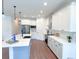 Modern kitchen with white cabinets, large island, and stainless steel appliances at 17423 Metcalf Ave, Port Charlotte, FL 33954