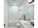 Clean bathroom, featuring a bathtub, double vanity, and modern fixtures at 17423 Metcalf Ave, Port Charlotte, FL 33954