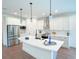 Modern kitchen with white cabinets, large island, and stainless steel appliances at 17423 Metcalf Ave, Port Charlotte, FL 33954