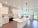Bright kitchen features white cabinets, stainless steel appliances, and an island at 17399 Masten Ave, Port Charlotte, FL 33954