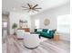 Bright and airy living room with a green velvet sofa and white accent chairs at 18078 Spartonvail Ave, Port Charlotte, FL 33954