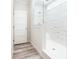 Modern bathroom featuring a walk-in shower with subway tile and wood-look vinyl flooring at 18078 Spartonvail Ave, Port Charlotte, FL 33954