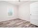 Bright bedroom with wood-look flooring and a window with plantation shutters at 18078 Spartonvail Ave, Port Charlotte, FL 33954
