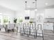 Modern white kitchen with an island, stainless steel appliances, and pendant lighting at 18078 Spartonvail Ave, Port Charlotte, FL 33954