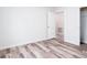 Well-lit bedroom with wood-look vinyl flooring and an adjacent closet at 18078 Spartonvail Ave, Port Charlotte, FL 33954