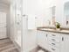 Elegant bathroom with double vanity, a walk-in shower, and wood-look flooring at 18078 Spartonvail Ave, Port Charlotte, FL 33954