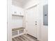 Inviting entryway with built-in bench, cubbies, and a coat rack at 18078 Spartonvail Ave, Port Charlotte, FL 33954