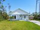 Cute one-story home with light blue siding, a front porch, and a well-maintained lawn at 18078 Spartonvail Ave, Port Charlotte, FL 33954