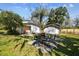 Spacious backyard with patio furniture, detached shed, and lush landscaping at 6605 N Boulevard, Tampa, FL 33604