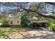 Ranch style home with carport and mature landscaping at 6605 N Boulevard, Tampa, FL 33604