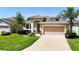 Beautiful one-story home with two car garage and manicured lawn at 29405 Cochiti Lake Dr, San Antonio, FL 33576