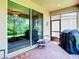 Relaxing screened patio with sliding glass doors and outdoor furniture at 29405 Cochiti Lake Dr, San Antonio, FL 33576