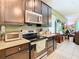 Modern kitchen with stainless steel appliances and granite countertops at 29405 Cochiti Lake Dr, San Antonio, FL 33576