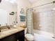 Bathroom with shower/tub combo, granite countertop and tile at 29405 Cochiti Lake Dr, San Antonio, FL 33576