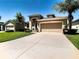 One-story house with tan exterior, attached garage, and landscaped lawn at 29405 Cochiti Lake Dr, San Antonio, FL 33576