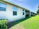 View of the home's exterior and side yard with well-maintained lawn at 29405 Cochiti Lake Dr, San Antonio, FL 33576