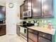 Updated kitchen with dark cabinetry, stainless steel appliances, and granite countertops at 29405 Cochiti Lake Dr, San Antonio, FL 33576