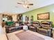 Open living room with leather furniture and views into the kitchen at 29405 Cochiti Lake Dr, San Antonio, FL 33576