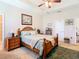 Spacious bedroom with wood furniture and ceiling fan at 29405 Cochiti Lake Dr, San Antonio, FL 33576