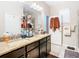 Double vanity bathroom with granite countertops and walk-in shower at 29405 Cochiti Lake Dr, San Antonio, FL 33576
