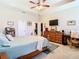Main bedroom with dresser, TV, and ceiling fan at 29405 Cochiti Lake Dr, San Antonio, FL 33576