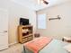 Bedroom with a double bed, TV stand and decorative shelving at 29405 Cochiti Lake Dr, San Antonio, FL 33576