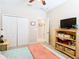 Bedroom with TV, double bed, and large closet at 29405 Cochiti Lake Dr, San Antonio, FL 33576