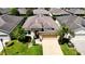 One-story house with tan exterior, attached garage, and landscaped lawn at 29405 Cochiti Lake Dr, San Antonio, FL 33576