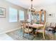 Bright dining room with a charming chandelier and wood table at 29405 Cochiti Lake Dr, San Antonio, FL 33576