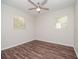 Well-lit bedroom featuring hardwood floors and a ceiling fan at 4415 W Wisconsin Ave, Tampa, FL 33616