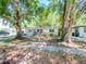 Updated bungalow with charming front porch and mature landscaping at 4415 W Wisconsin Ave, Tampa, FL 33616