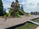 Community playground with slides, climbing structures, and shaded areas at 11412 Bridge Pine Dr, Riverview, FL 33569