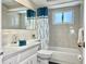 Clean bathroom with teal shower curtain and white vanity at 3615 Wellington Dr, Holiday, FL 34691