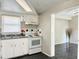 White kitchen with stainless steel appliances and tile floor at 3615 Wellington Dr, Holiday, FL 34691