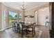 Formal dining room with large window and chandelier at 849 John Cressler Dr, Seffner, FL 33584